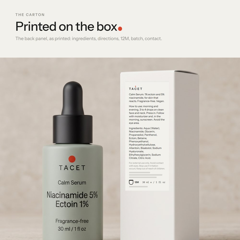 Tacet Calm Serum bottle beside its chalk carton, turned to show the back panel, on travertine